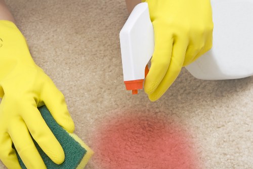 Professional cleaner in Harrow cleaning a modern living room