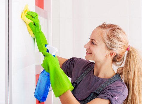 Professional carpet cleaner in Harrow deep cleaning a living room carpet
